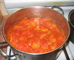 Photo of tomatoes stewing in a pot.