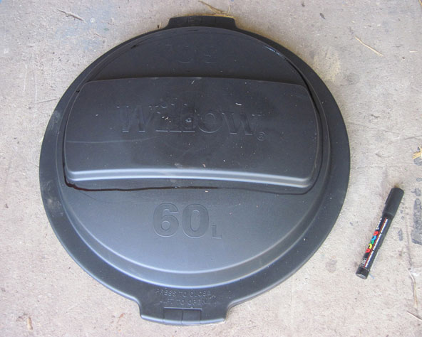 Large photo of Rubbish bin lid with section to be cut out marked with a marker pen